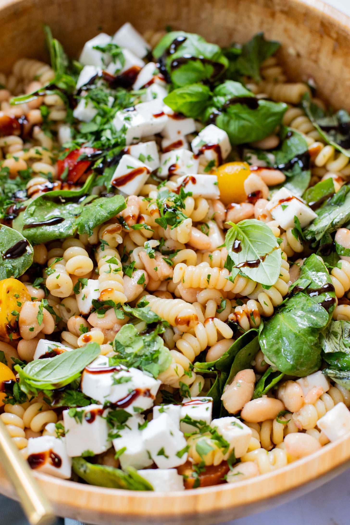 This White Bean Balsamic Pasta Salad is a summer must make! Made with vegan feta, cherry tomatoes, herbs, white beans & balsamic dressing | ThisSavoryVegan.com