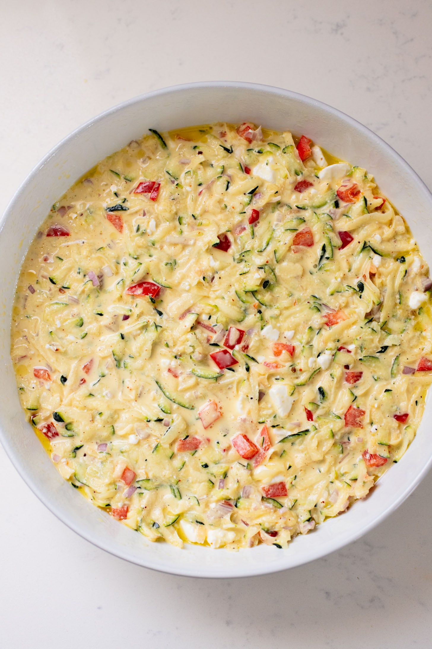 This Zucchini & Potato Vegan Egg Bake is the perfect summer brunch idea! Shredded zucchini & potatoes are baked with Just Egg | ThisSavoryVegan.com