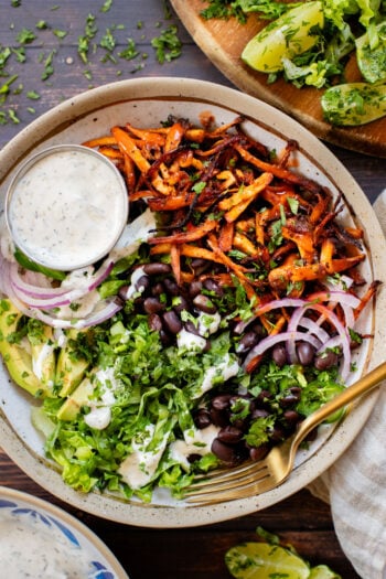 These Buffalo Oyster Mushroom Bowls are an easy vegan weeknight dinner! Layered with brown rice, black beans, crispy mushrooms & vegan ranch | ThisSavoryVegan.com