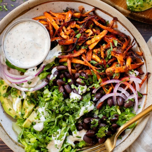 These Buffalo Oyster Mushroom Bowls are an easy vegan weeknight dinner! Layered with brown rice, black beans, crispy mushrooms & vegan ranch | ThisSavoryVegan.com