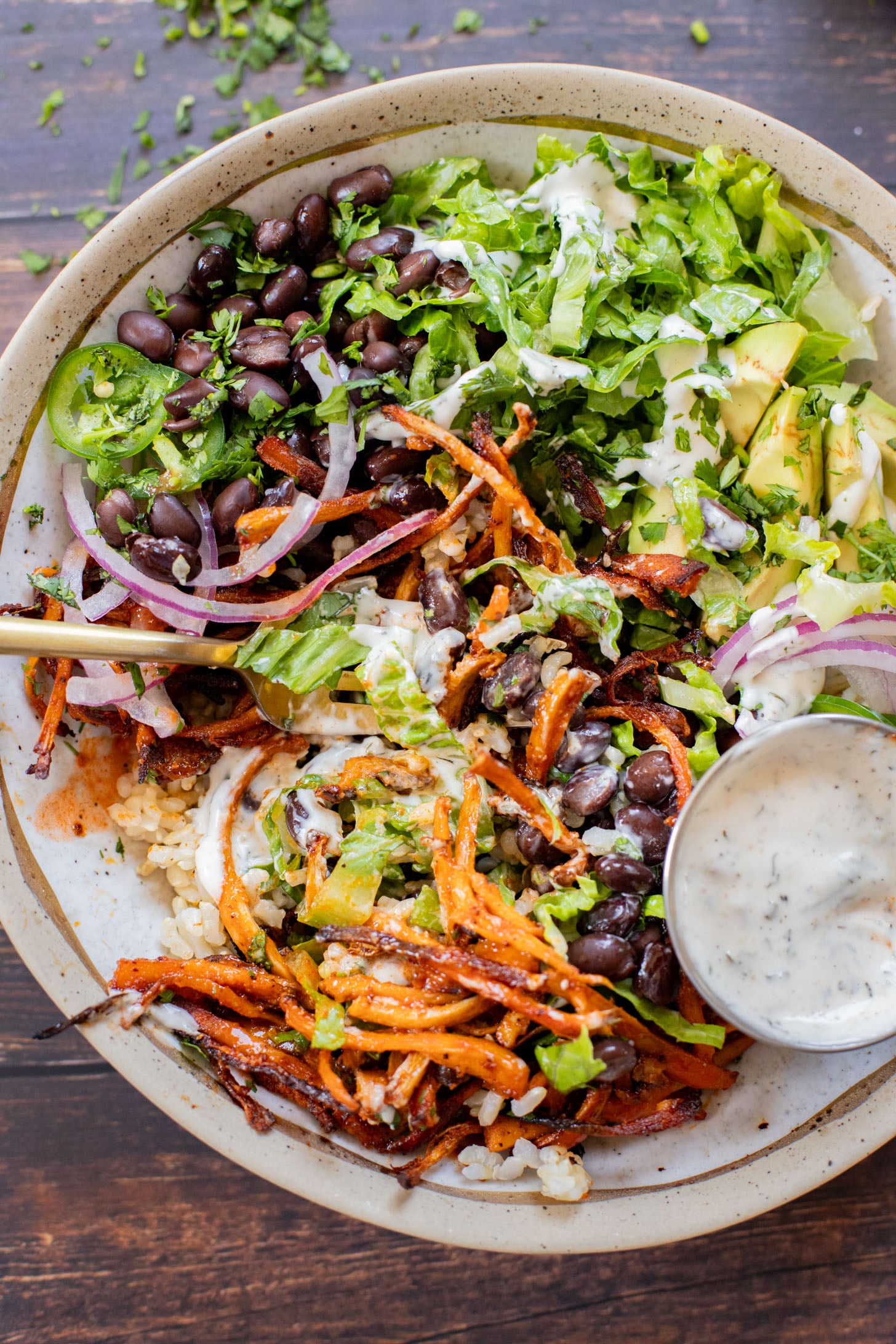 These Buffalo Oyster Mushroom Bowls are an easy vegan weeknight dinner! Layered with brown rice, black beans, crispy mushrooms & vegan ranch | ThisSavoryVegan.com