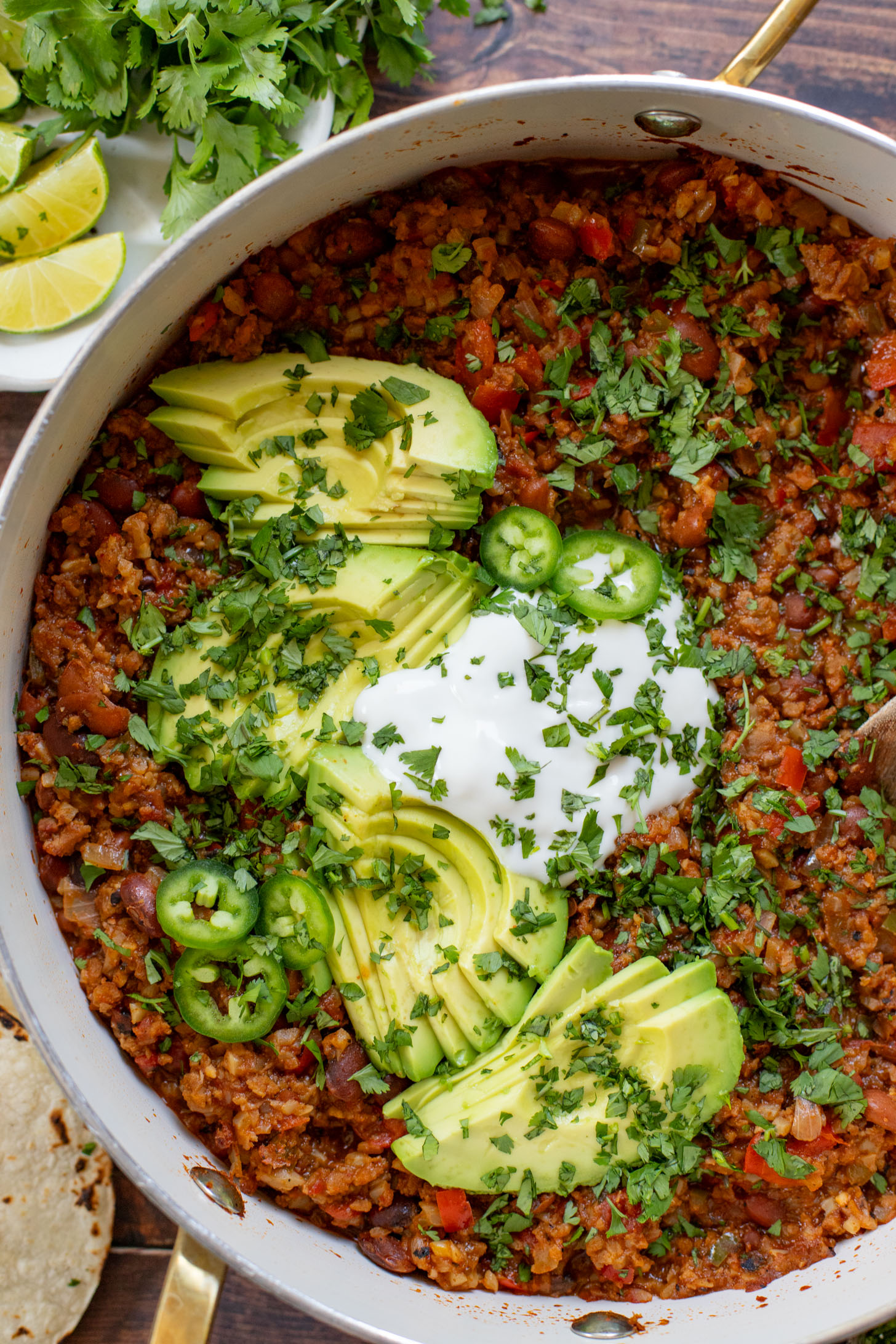 If you are in need of a low carb vegan dinner idea then you need to try this Cauliflower Rice Taco Skillet! Filled with veggies, beans & TONS of flavor | ThisSavoryVegan.com
