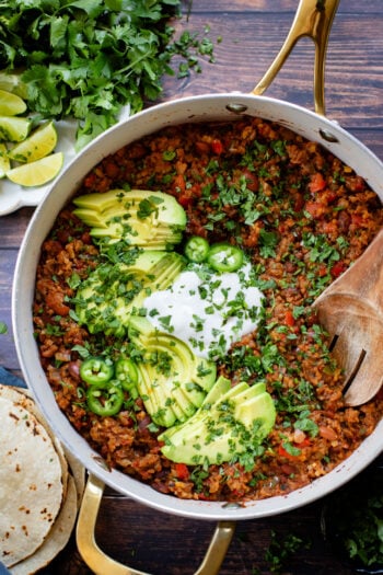If you are in need of a low carb vegan dinner idea then you need to try this Cauliflower Rice Taco Skillet! Filled with veggies, beans & TONS of flavor | ThisSavoryVegan.com
