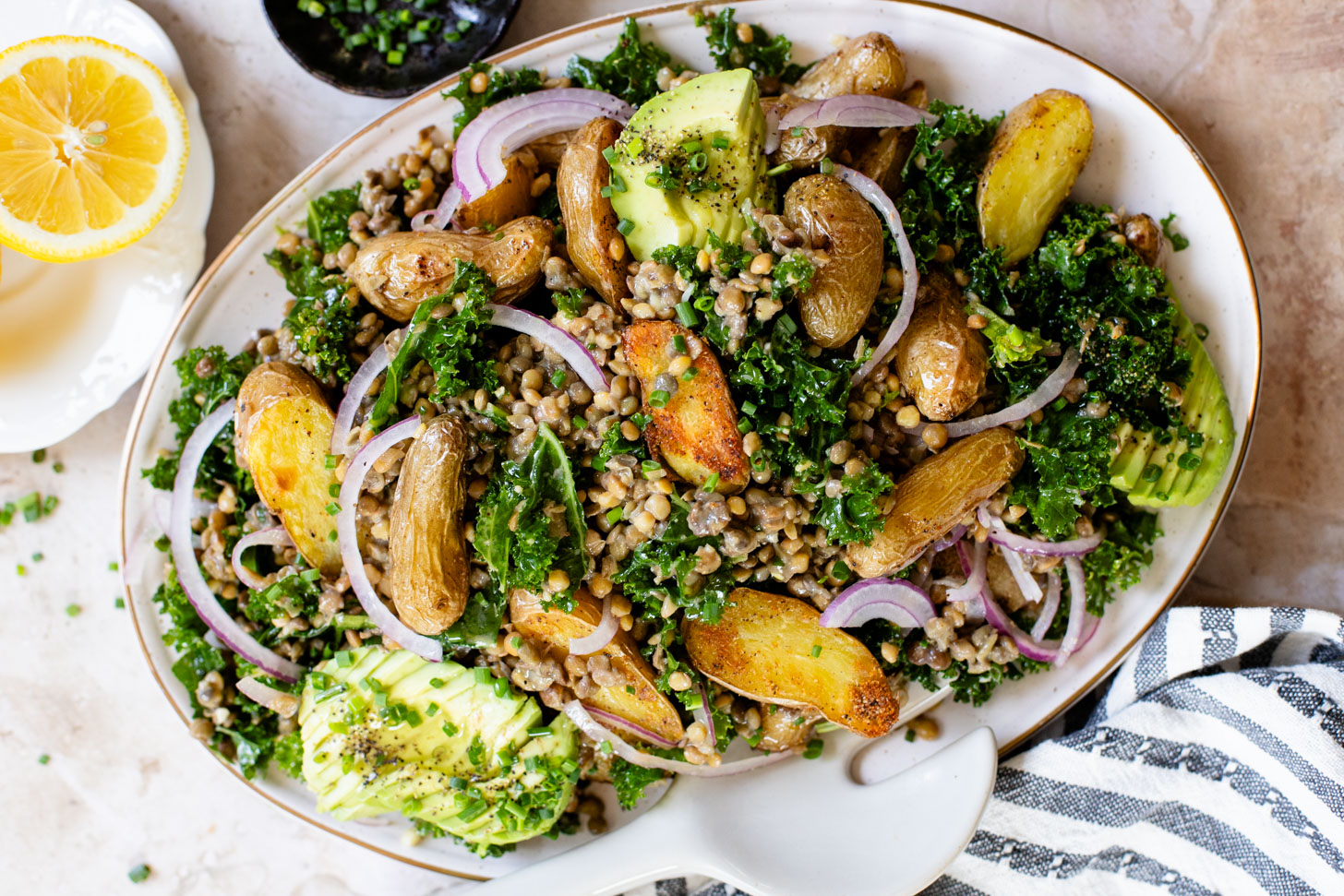 This Fingerling Potato & Lentil Salad is layered with crunchy kale, roasted potatoes, chilled lentils, avocado & a lemon chive dressing | ThisSavoryVegan.com