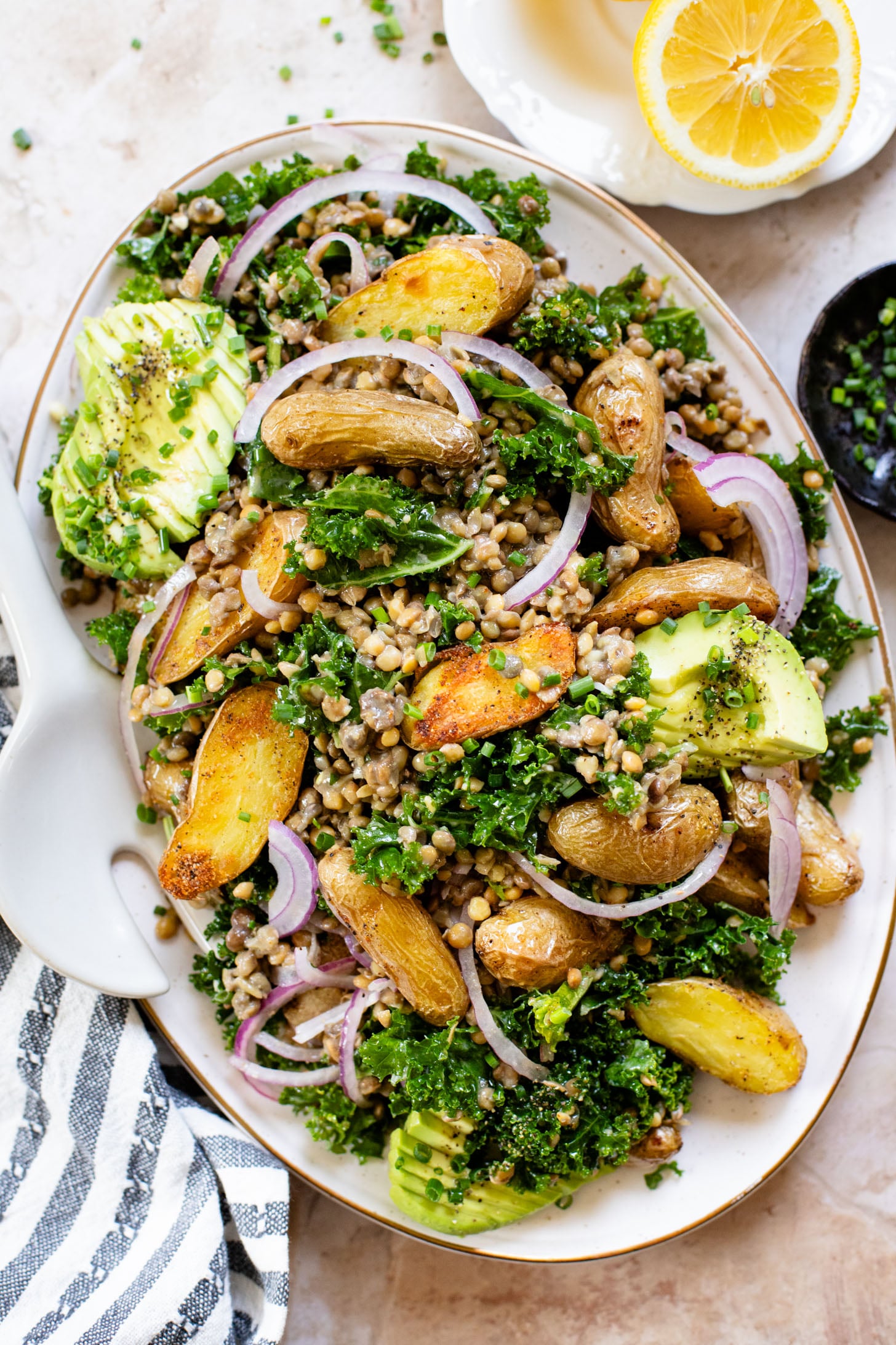 This Fingerling Potato & Lentil Salad is layered with crunchy kale, roasted potatoes, chilled lentils, avocado & a lemon chive dressing | ThisSavoryVegan.com