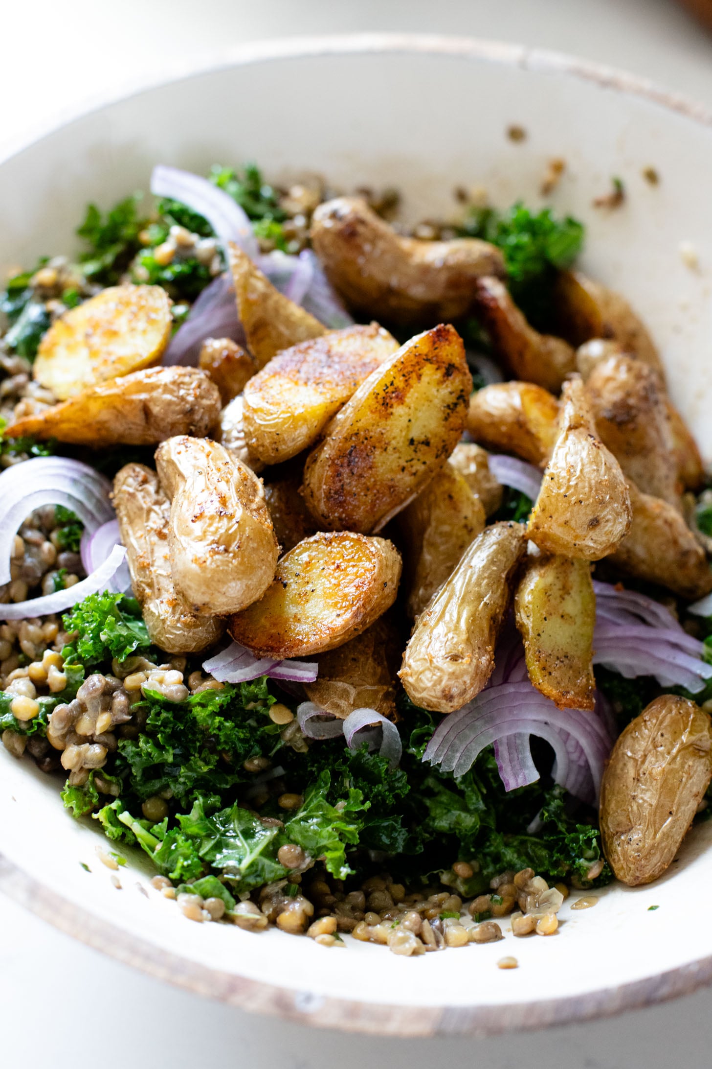 This Fingerling Potato & Lentil Salad is layered with crunchy kale, roasted potatoes, chilled lentils, avocado & a lemon chive dressing | ThisSavoryVegan.com