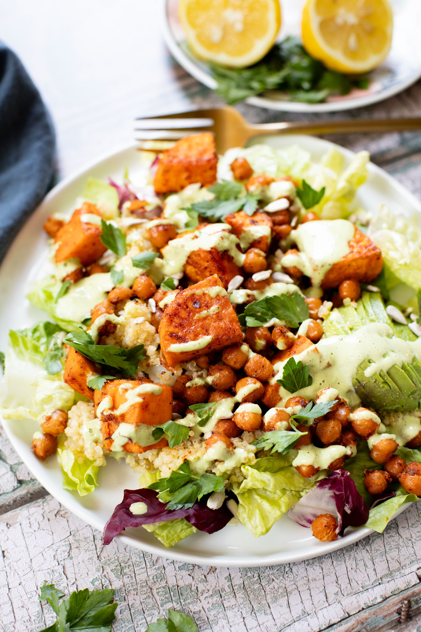 This Roasted Sweet Potato Salad is the perfect quick lunch or dinner! Served with quinoa, greens, avocado & tahini dressing | ThisSavoryVegan.com
