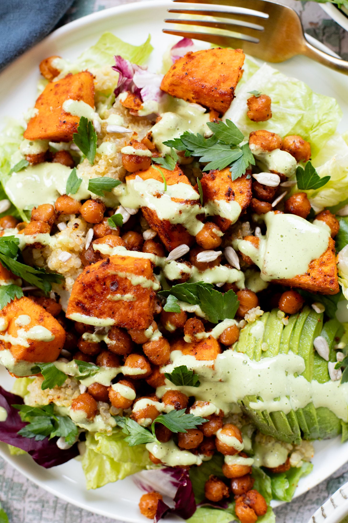 This Roasted Sweet Potato Salad is the perfect quick lunch or dinner! Served with quinoa, greens, avocado & tahini dressing | ThisSavoryVegan.com