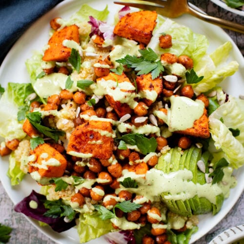 This Roasted Sweet Potato Salad is the perfect quick lunch or dinner! Served with quinoa, greens, avocado & tahini dressing | ThisSavoryVegan.com