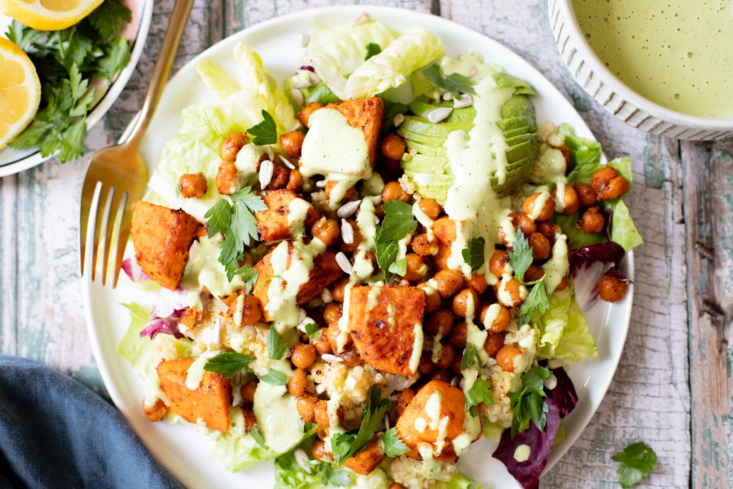 This Roasted Sweet Potato Salad is the perfect quick lunch or dinner! Served with quinoa, greens, avocado & tahini dressing | ThisSavoryVegan.com
