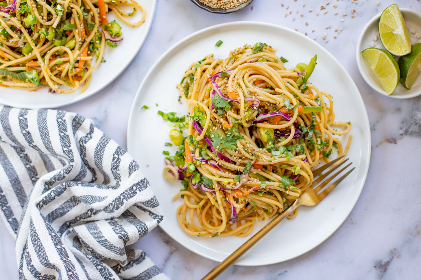 This Sesame Ginger Noodle Salad is filled with TONS of veggies, cold noodles and a super tasty homemade sesame ginger dressing | ThisSavoryVegan.com