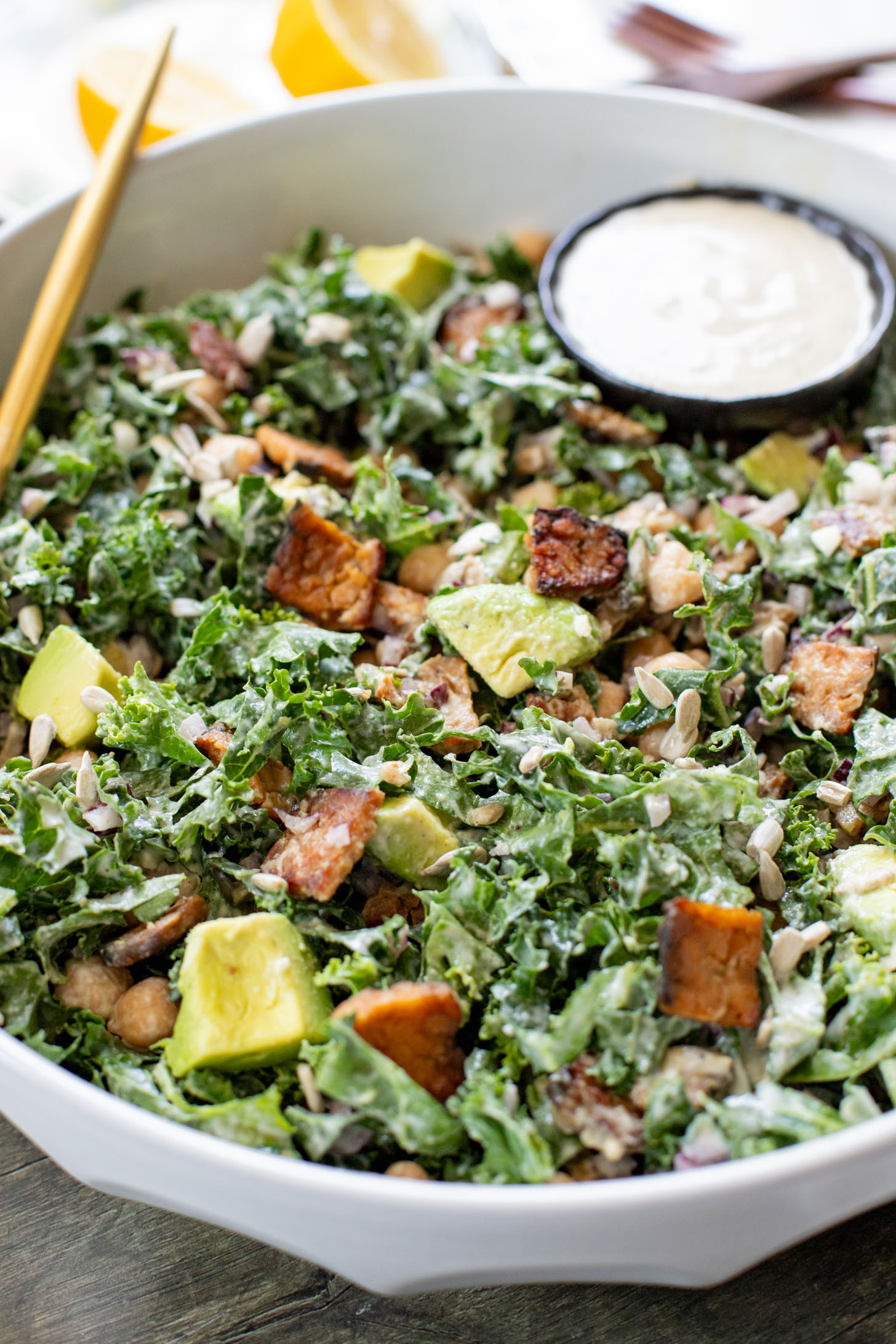 Healthy & delicious, this Tempeh Bacon Kale Salad is a vegan dream! Made with crispy tempeh bacon, chickpeas, avocado & lemon tahini dressing | ThisSavoryVegan.com