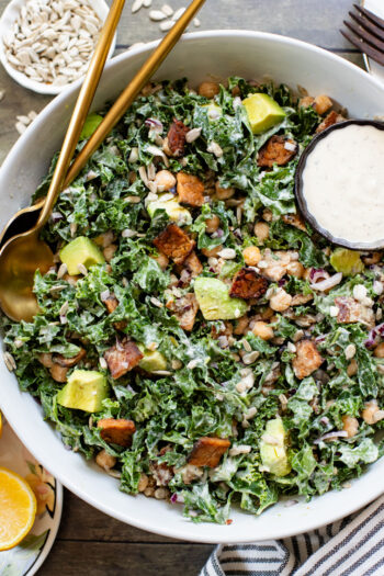 Healthy & delicious, this Tempeh Bacon Kale Salad is a vegan dream! Made with crispy tempeh bacon, chickpeas, avocado & lemon tahini dressing | ThisSavoryVegan.com
