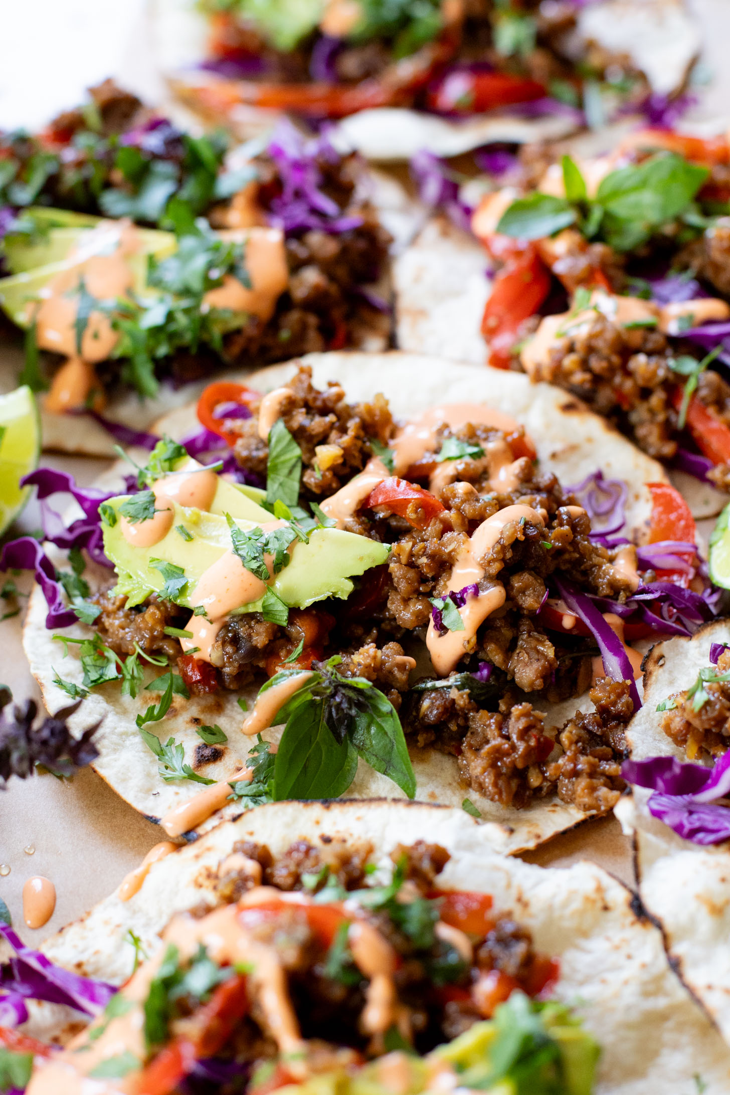 These Vegan Thai Beef Tacos are an explosion of flavor - filled with soy "beef" crumbles in a Thai-inspired sauce, spicy mayo, avocado & cabbage | ThisSavoryVegan.com