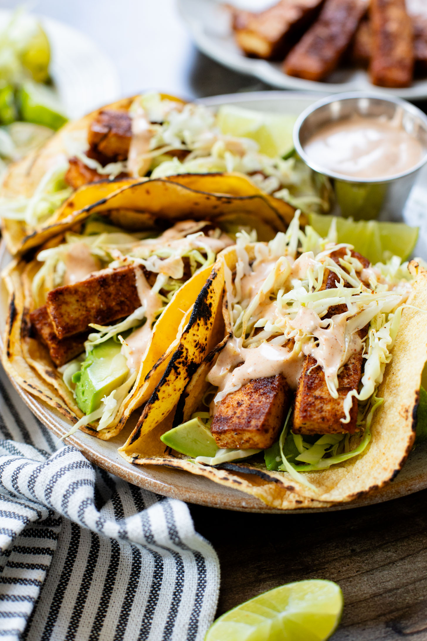 These Blackened Tofu Tacos are layered with crispy tofu, shredded cabbage, avocado and a creamy vegan sauce | ThisSavoryVegan.com