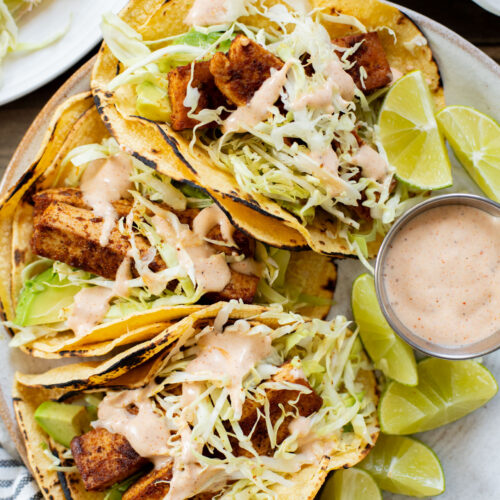 These Blackened Tofu Tacos are layered with crispy tofu, shredded cabbage, avocado and a creamy vegan sauce | ThisSavoryVegan.com