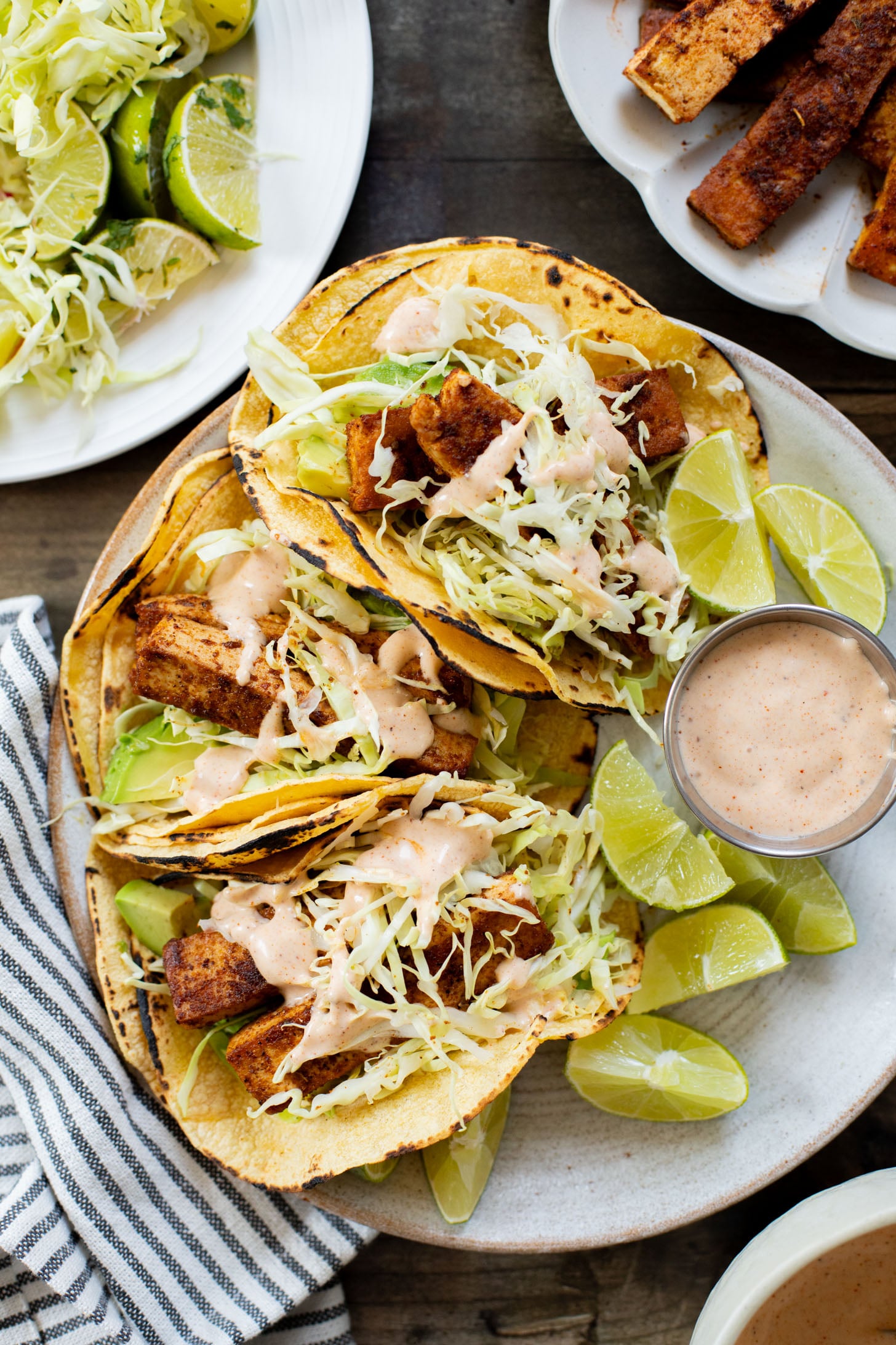 These Blackened Tofu Tacos are layered with crispy tofu, shredded cabbage, avocado and a creamy vegan sauce | ThisSavoryVegan.com