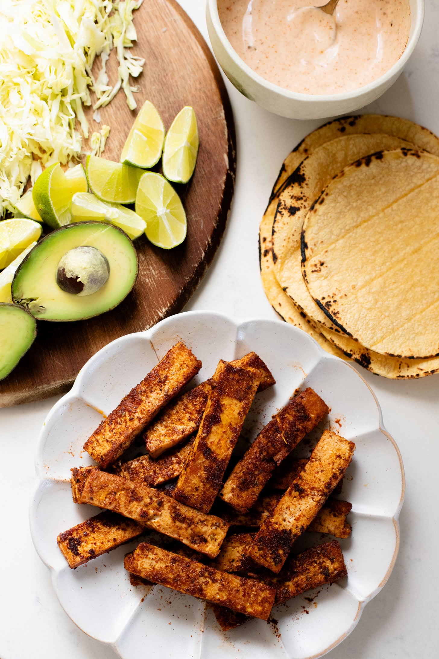 These Blackened Tofu Tacos are layered with crispy tofu, shredded cabbage, avocado and a creamy vegan sauce | ThisSavoryVegan.com