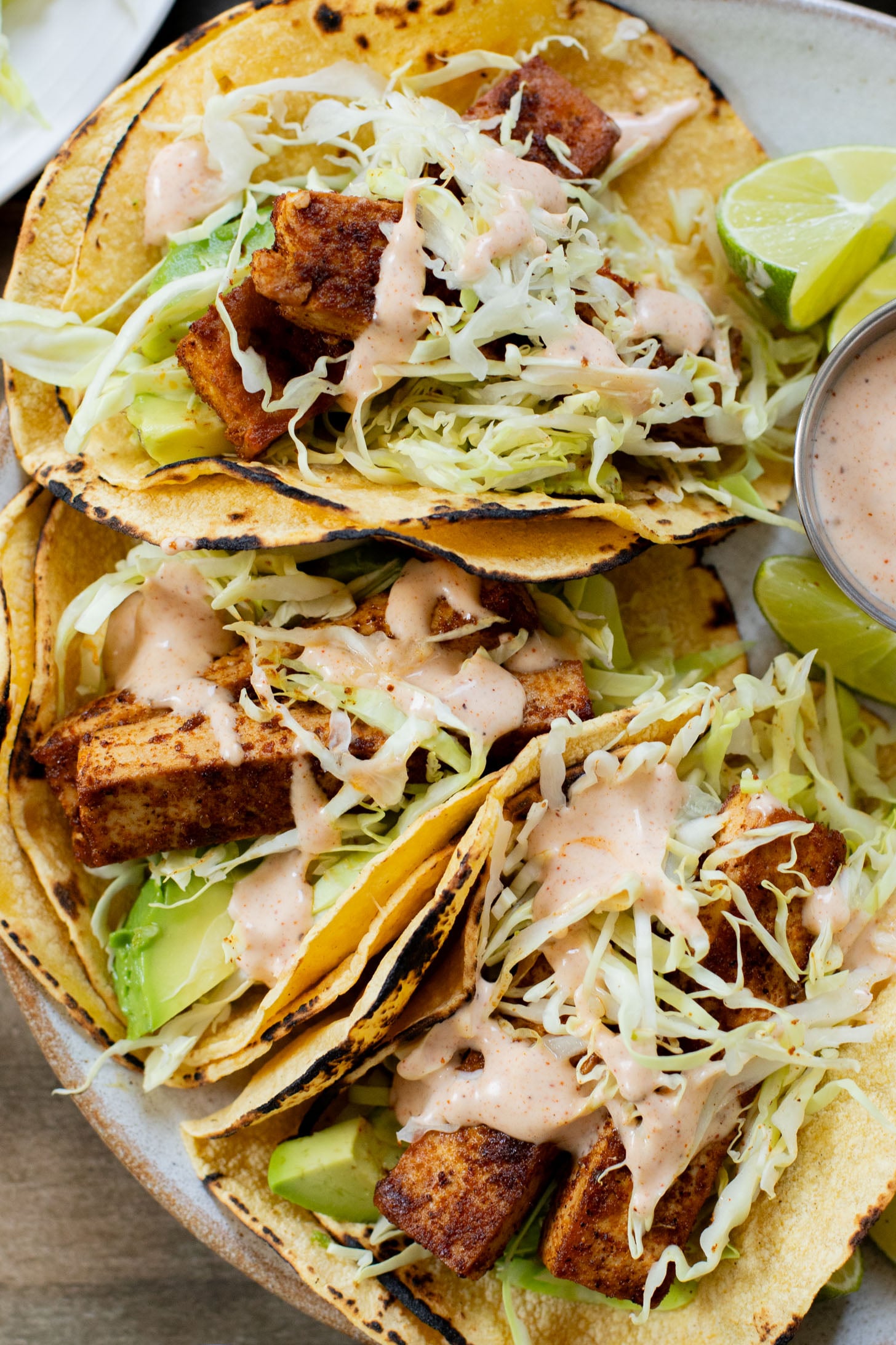 These Blackened Tofu Tacos are layered with crispy tofu, shredded cabbage, avocado and a creamy vegan sauce | ThisSavoryVegan.com
