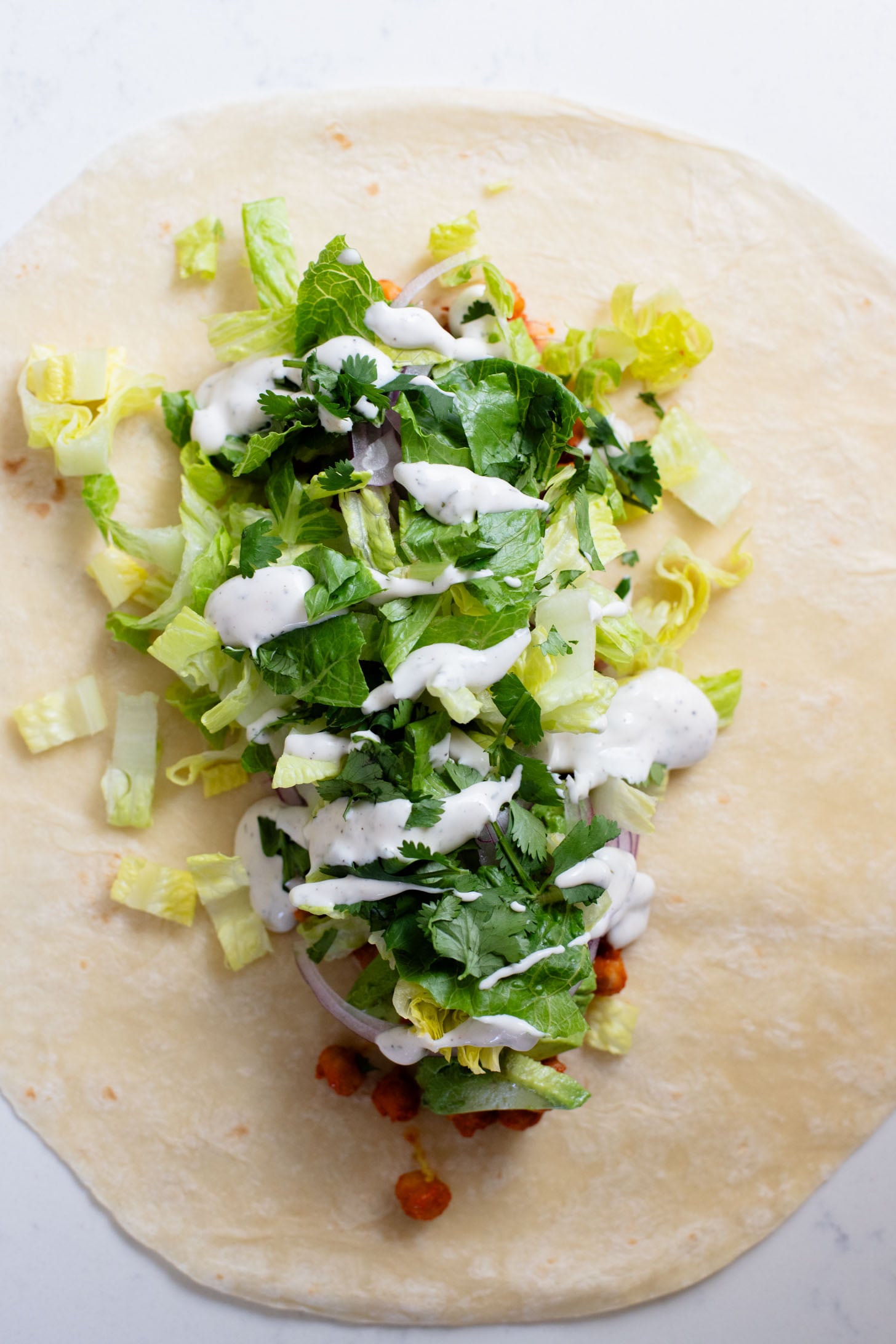 These Buffalo Chickpea Ranch Wraps are the perfect vegan lunch on the go! Buffalo chickpeas, vegan ranch & veggies wrapped in a tortilla | ThisSavoryVegan.com
