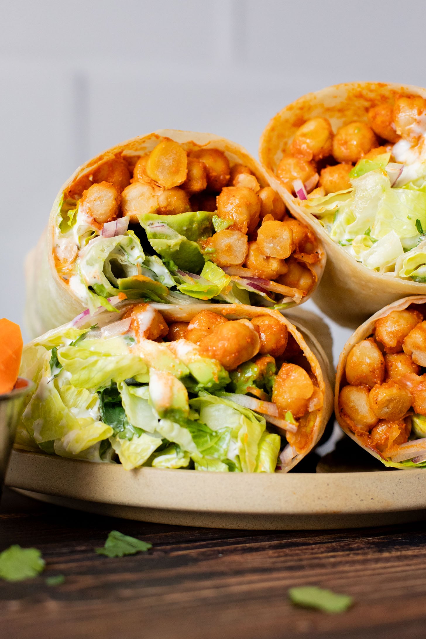 These Buffalo Chickpea Ranch Wraps are the perfect vegan lunch on the go! Buffalo chickpeas, vegan ranch & veggies wrapped in a tortilla | ThisSavoryVegan.com