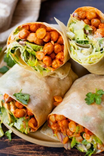 These Buffalo Chickpea Ranch Wraps are the perfect vegan lunch on the go! Buffalo chickpeas, vegan ranch & veggies wrapped in a tortilla | ThisSavoryVegan.com