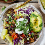These Salsa Verde Black Bean Bowls are quick, easy & tasty. The bowls are filled with quinoa, seasoned beans & lots of veggies | ThisSavoryVegan.com