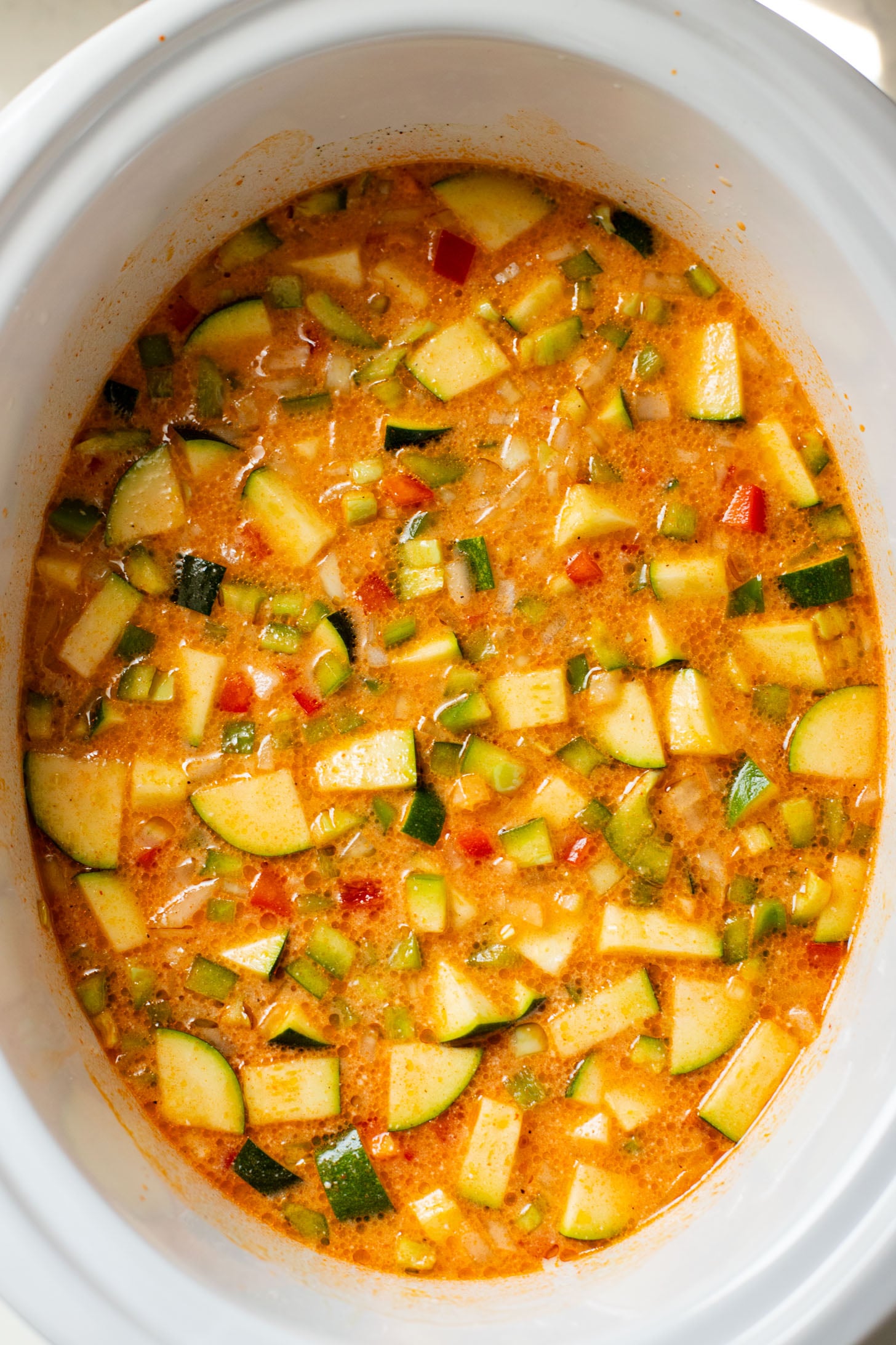 This Slow Cooker Veggie Curry Soup is a vegan dinner dream! Very little prep time, tons of veggies and zero cooking required | ThisSavoryVegan.com