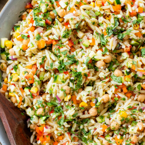 This Summer Veggie Orzo Salad is packed with chilled orzo, chickpeas, crisp veggies, and a light chipotle dressing. Perfect for lunches or a party | ThisSavoryVegan.com