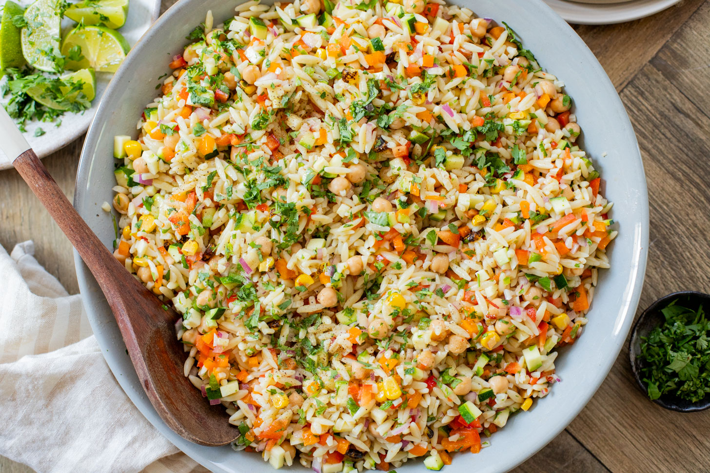 This Summer Veggie Orzo Salad is packed with chilled orzo, chickpeas, crisp veggies, and a light chipotle dressing. Perfect for lunches or a party | ThisSavoryVegan.com