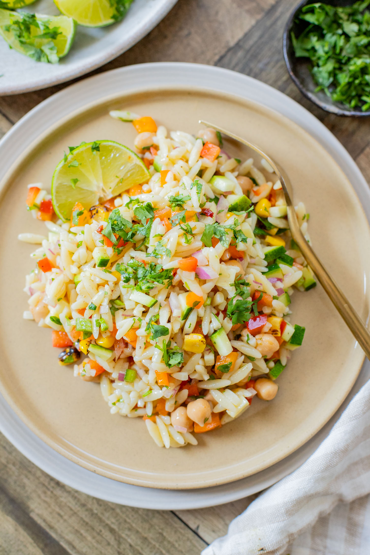 This Summer Veggie Orzo Salad is packed with chilled orzo, chickpeas, crisp veggies, and a light chipotle dressing. Perfect for lunches or a party | ThisSavoryVegan.com