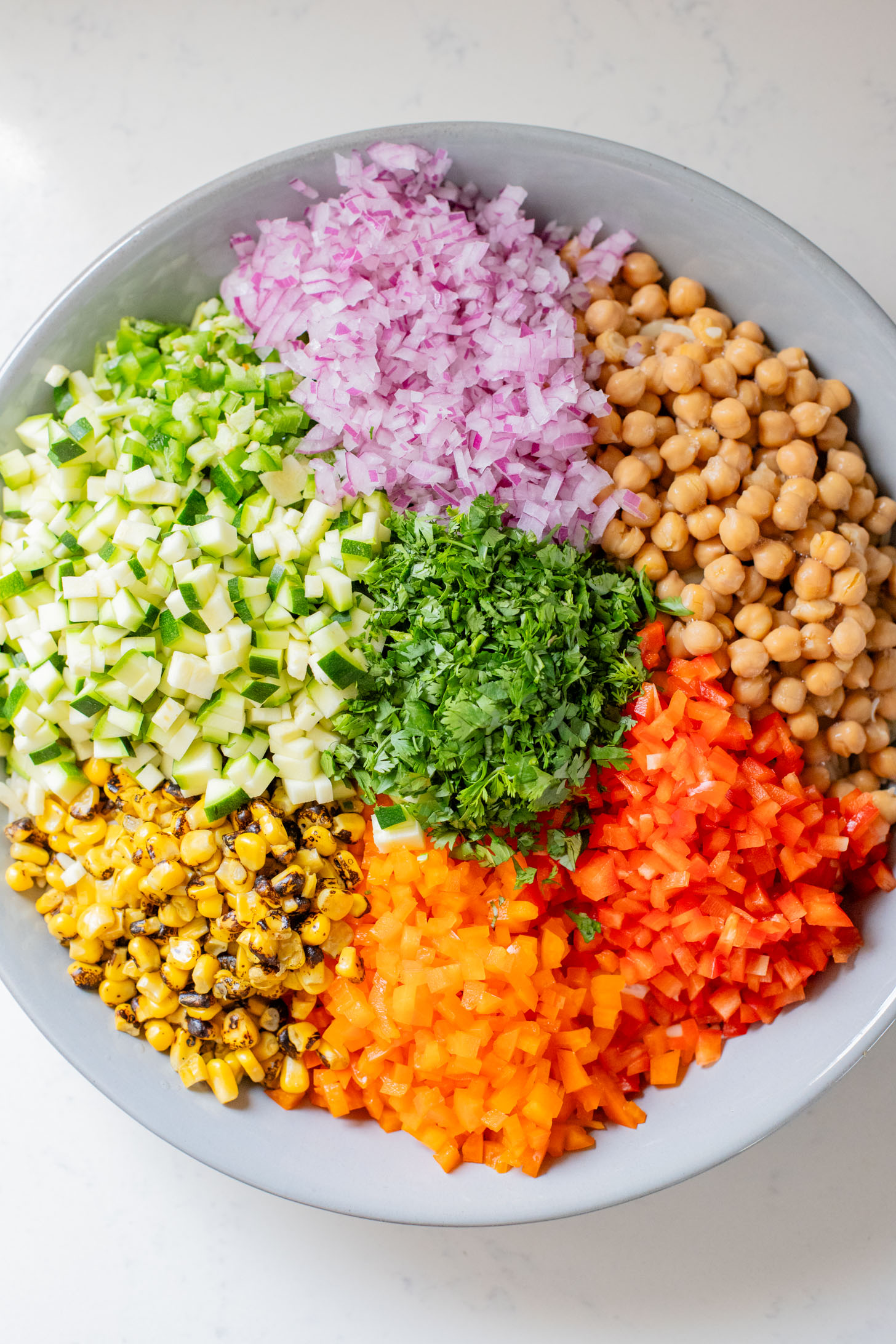 This Summer Veggie Orzo Salad is packed with chilled orzo, chickpeas, crisp veggies, and a light chipotle dressing. Perfect for lunches or a party | ThisSavoryVegan.com