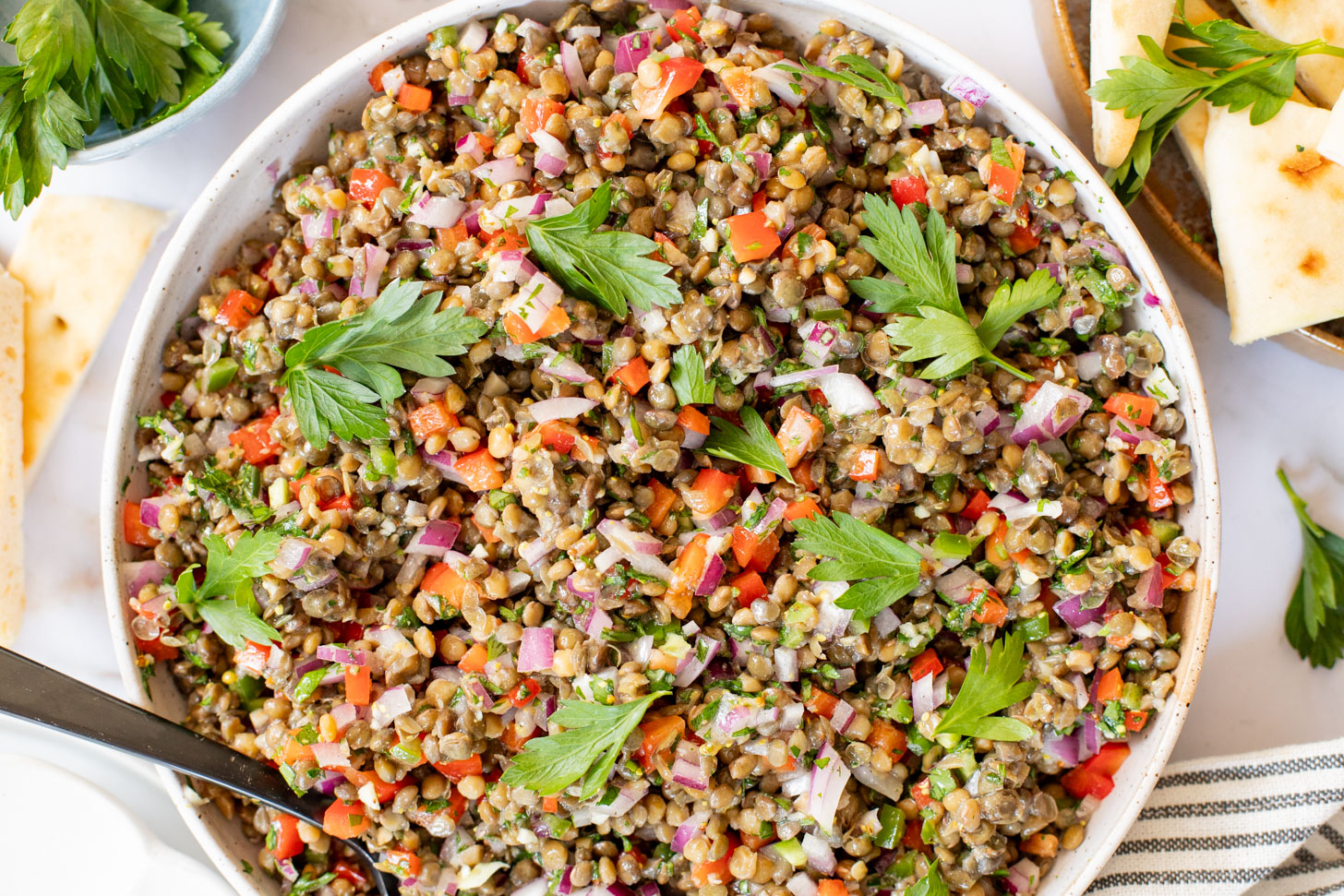 This Super Yummy Lentil Salad is ready in 15 minutes! Packed with veggies, protein and the perfect lemon garlic vinaigrette | ThisSavoryVegan.com