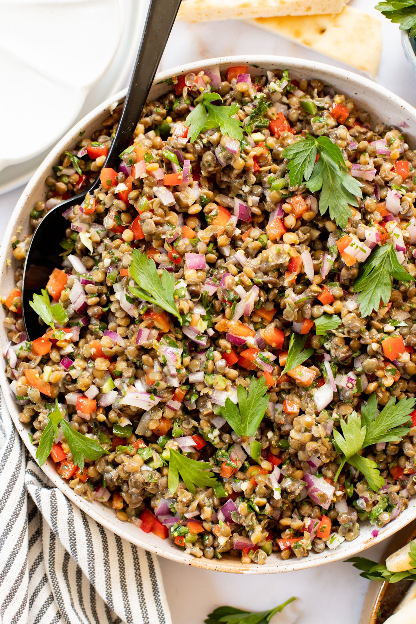 This Super Yummy Lentil Salad is ready in 15 minutes! Packed with veggies, protein and the perfect lemon garlic vinaigrette | ThisSavoryVegan.com