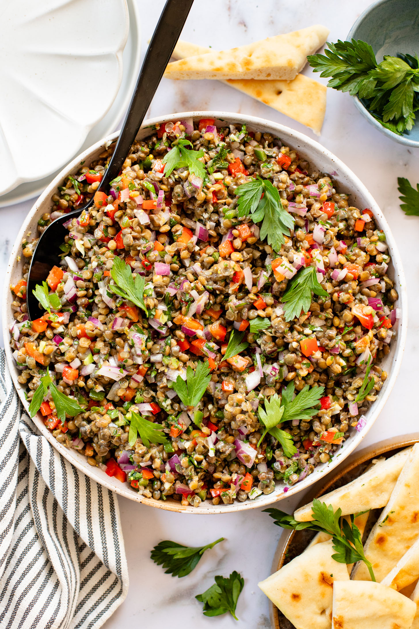 This Super Yummy Lentil Salad is ready in 15 minutes! Packed with veggies, protein and the perfect lemon garlic vinaigrette | ThisSavoryVegan.com