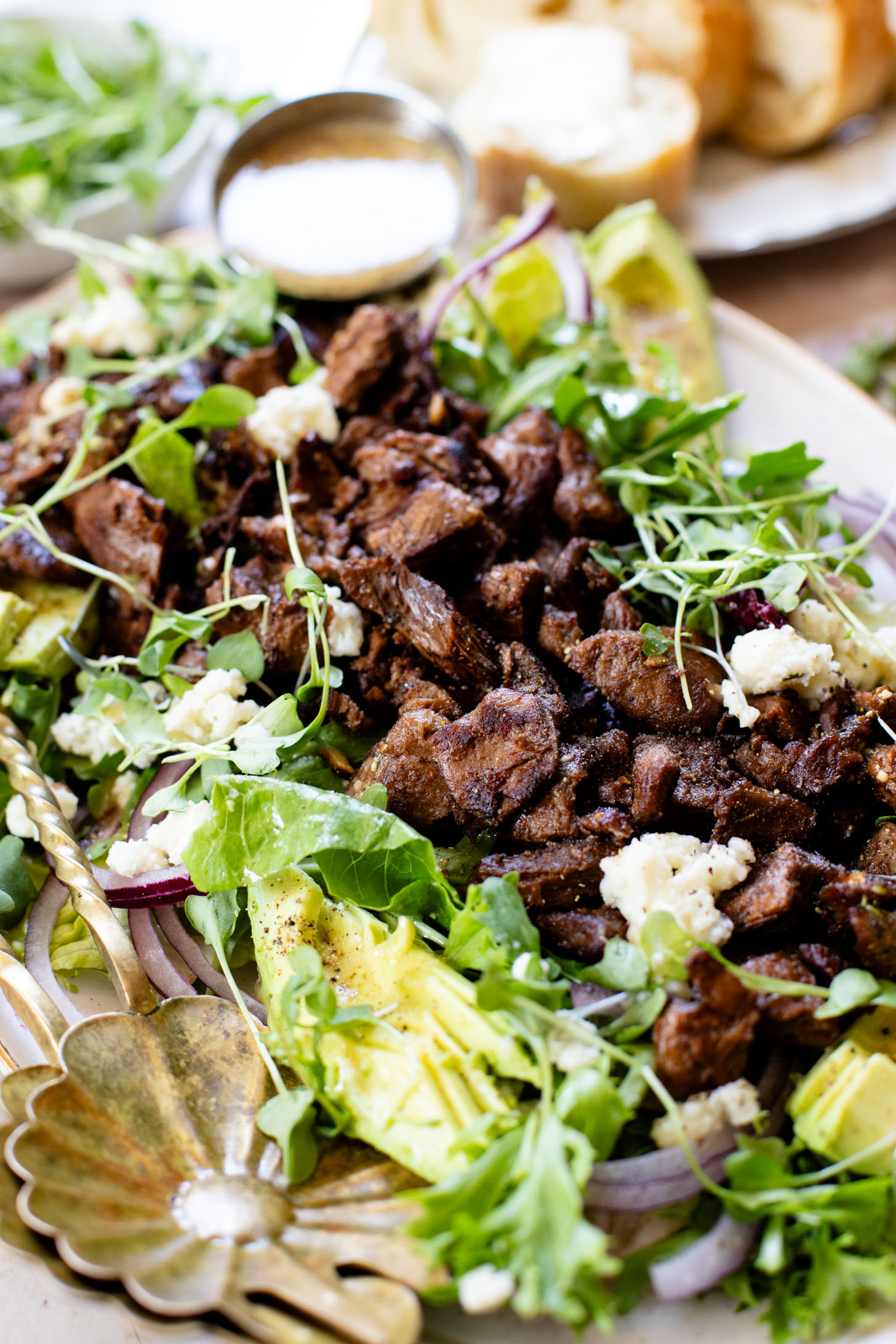This Vegan Steak Salad is easy, protein-packed and delicious! Served with a simple vinaigrette, vegan cheese, avocado & red onion | ThisSavoryVegan.com