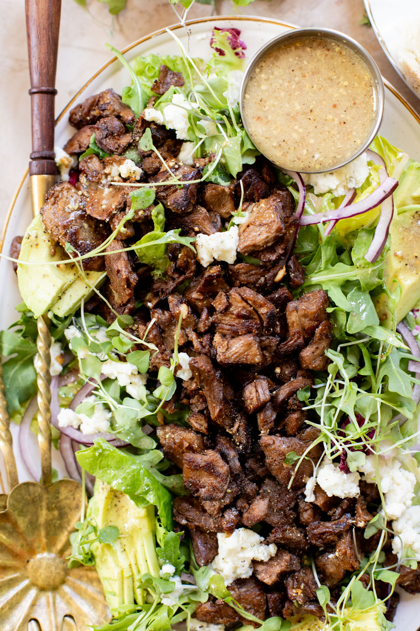 This Vegan Steak Salad is easy, protein-packed and delicious! Served with a simple vinaigrette, vegan cheese, avocado & red onion | ThisSavoryVegan.com