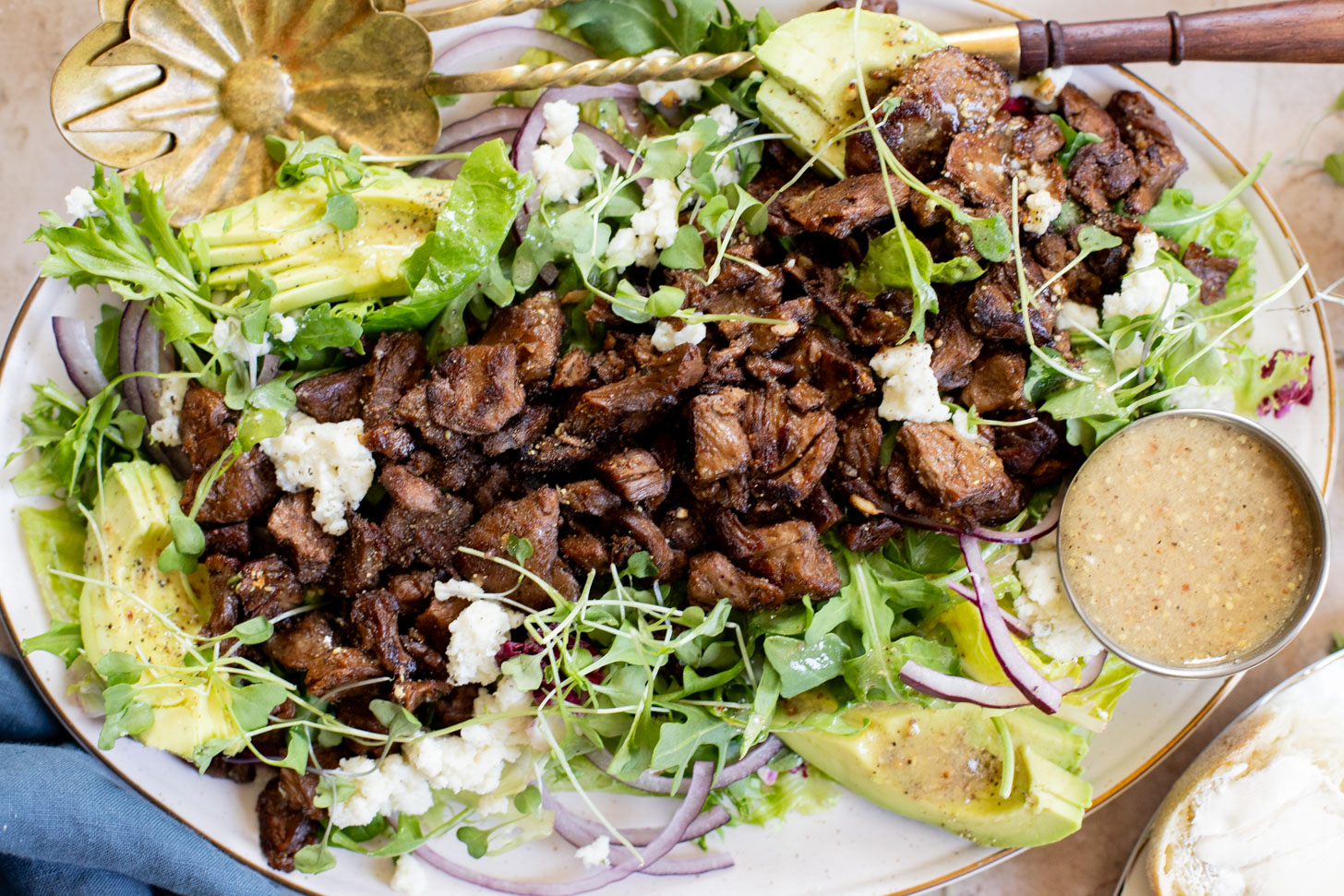 This Vegan Steak Salad is easy, protein-packed and delicious! Served with a simple vinaigrette, vegan cheese, avocado & red onion | ThisSavoryVegan.com