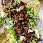 This Vegan Steak Salad is easy, protein-packed and delicious! Served with a simple vinaigrette, vegan cheese, avocado & red onion | ThisSavoryVegan.com