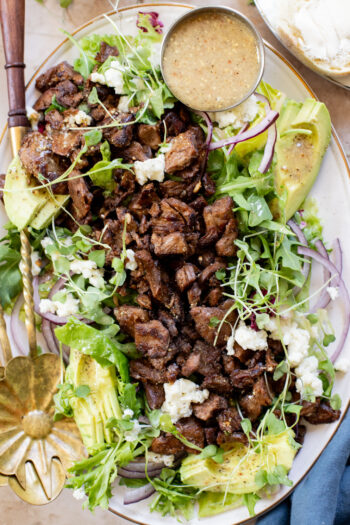 This Vegan Steak Salad is easy, protein-packed and delicious! Served with a simple vinaigrette, vegan cheese, avocado & red onion | ThisSavoryVegan.com