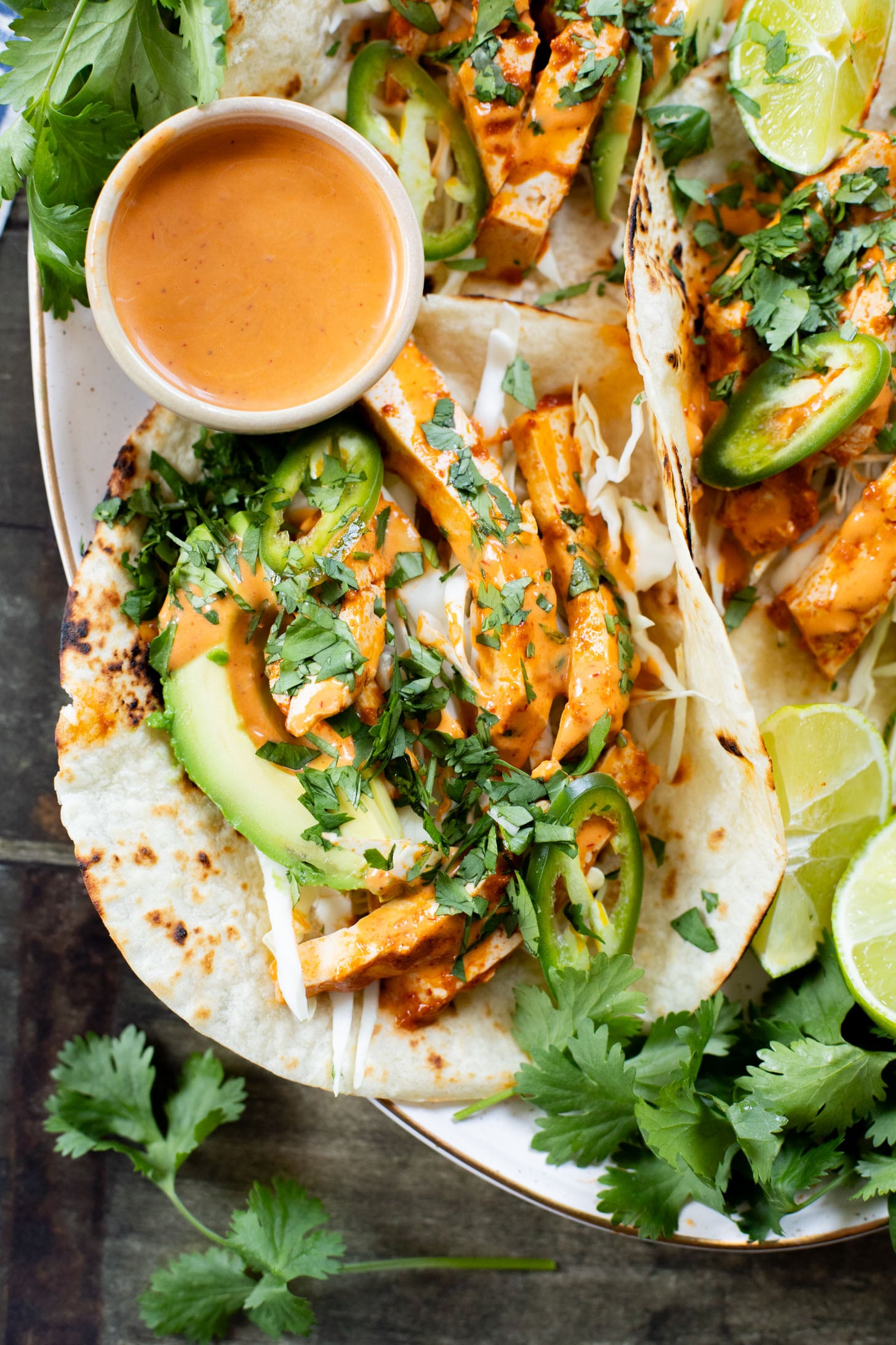 These Baked Chipotle Tofu Tacos are layered with marinated & baked tofu, cabbage, cilantro & a creamy dairy-free chipotle sauce | ThisSavoryVegan.com