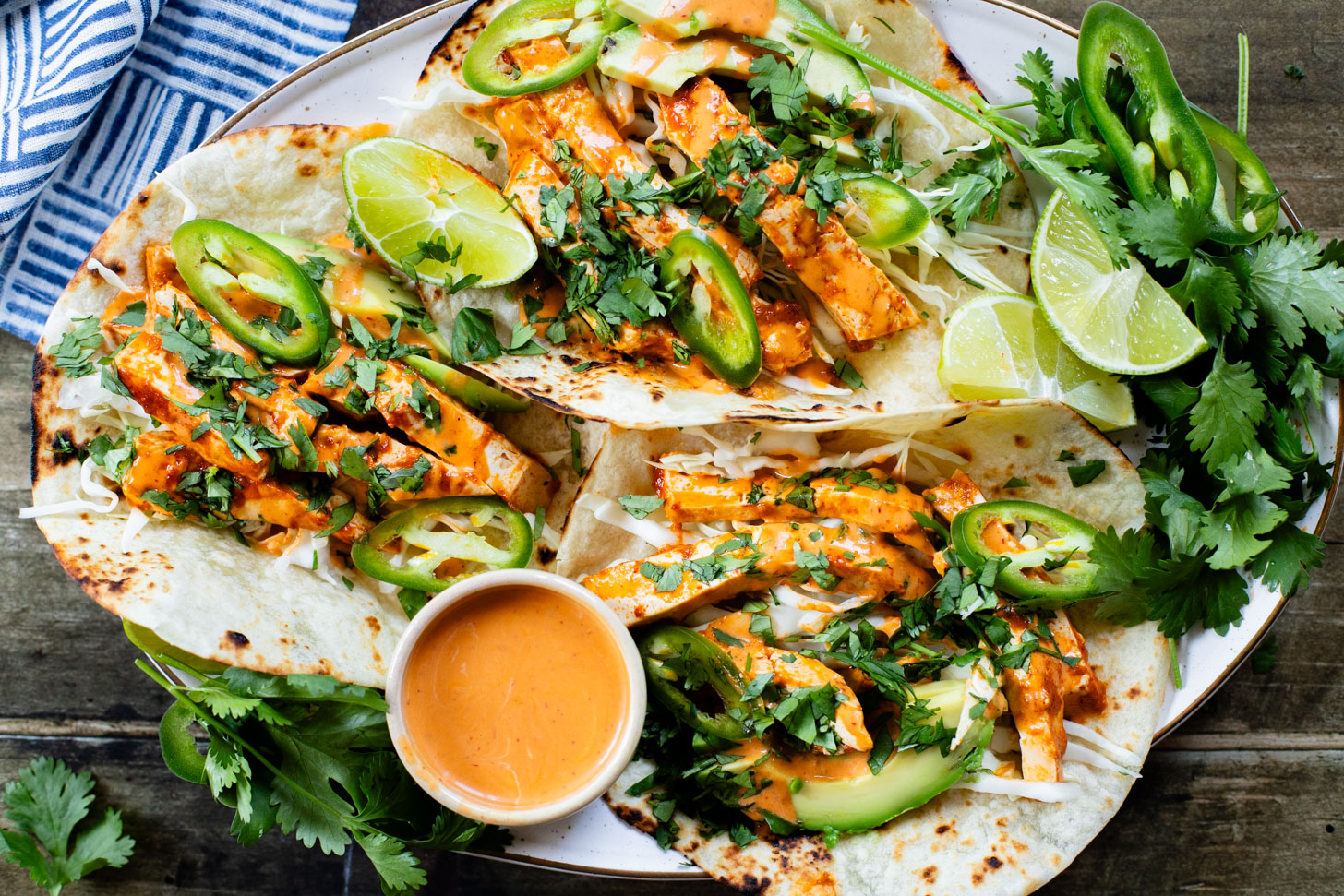 These Baked Chipotle Tofu Tacos are layered with marinated & baked tofu, cabbage, cilantro & a creamy dairy-free chipotle sauce | ThisSavoryVegan.com