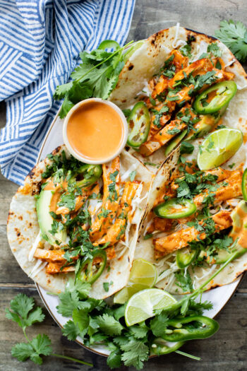 These Baked Chipotle Tofu Tacos are layered with marinated & baked tofu, cabbage, cilantro & a creamy dairy-free chipotle sauce | ThisSavoryVegan.com