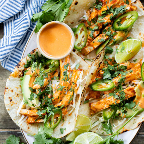 These Baked Chipotle Tofu Tacos are layered with marinated & baked tofu, cabbage, cilantro & a creamy dairy-free chipotle sauce | ThisSavoryVegan.com