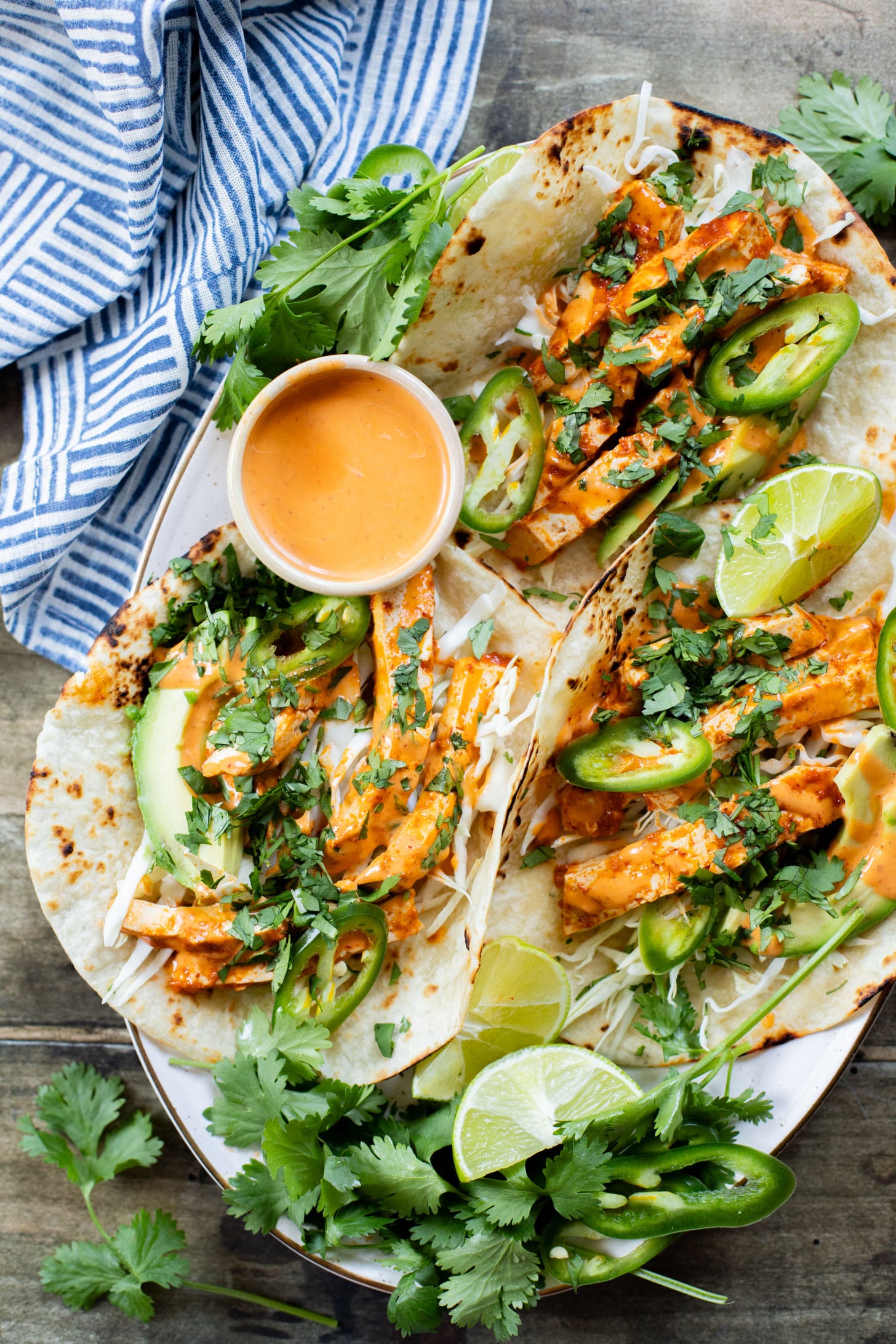 These Baked Chipotle Tofu Tacos are layered with marinated & baked tofu, cabbage, cilantro & a creamy dairy-free chipotle sauce | ThisSavoryVegan.com