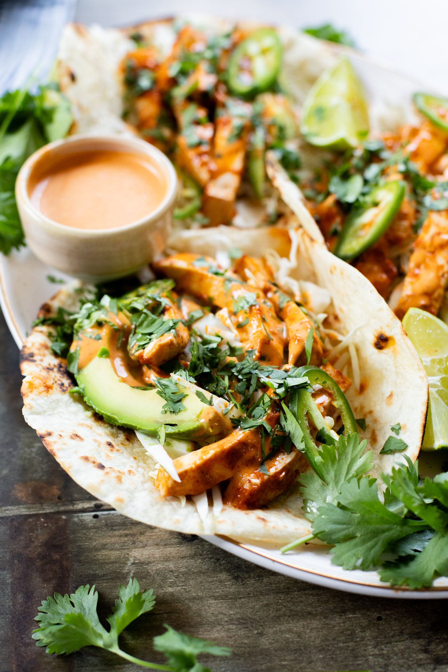 These Baked Chipotle Tofu Tacos are layered with marinated & baked tofu, cabbage, cilantro & a creamy dairy-free chipotle sauce | ThisSavoryVegan.com