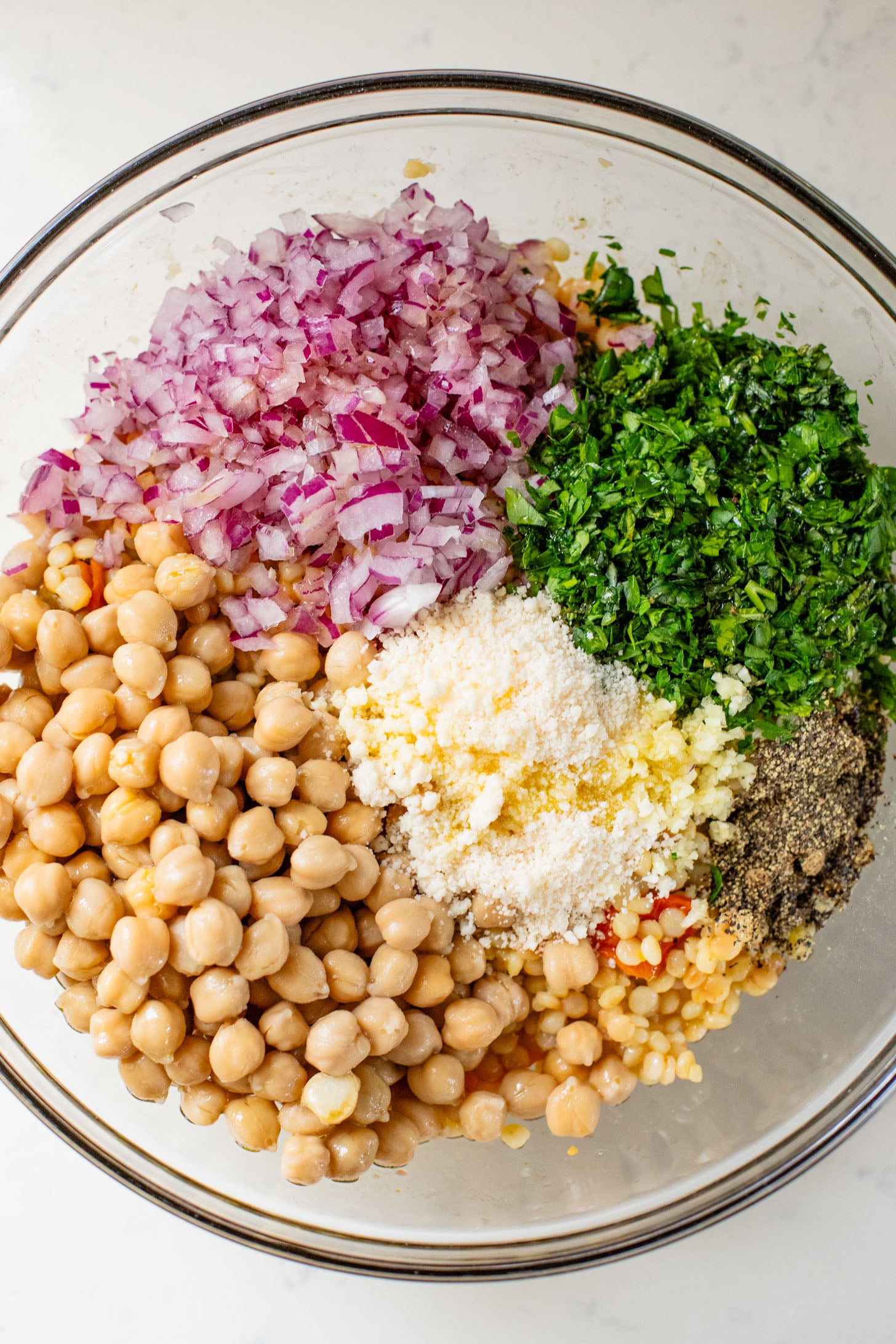 This Lemon Herb Couscous Salad is packed with fresh herbs, chickpeas, vegan parmesan and a simple & delicious dressing | ThisSavoryVegan.com