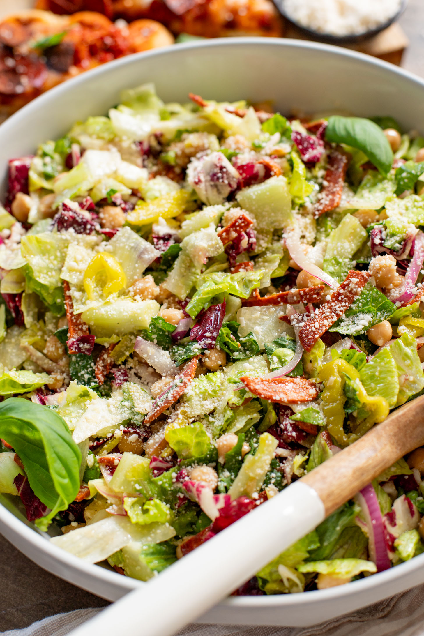 This Pizza Night Chopped Salad is the perfect side for, you guessed it, pizza night! Crunchy veggies, vegan pepperoni & a tangy dressing | ThisSavoryVegan.com