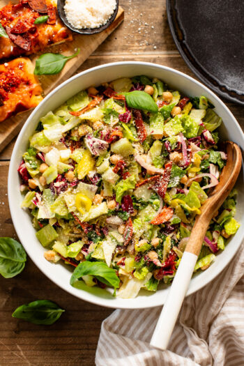 This Pizza Night Chopped Salad is the perfect side for, you guessed it, pizza night! Crunchy veggies, vegan pepperoni & a tangy dressing | ThisSavoryVegan.com