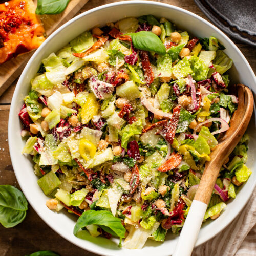 This Pizza Night Chopped Salad is the perfect side for, you guessed it, pizza night! Crunchy veggies, vegan pepperoni & a tangy dressing | ThisSavoryVegan.com